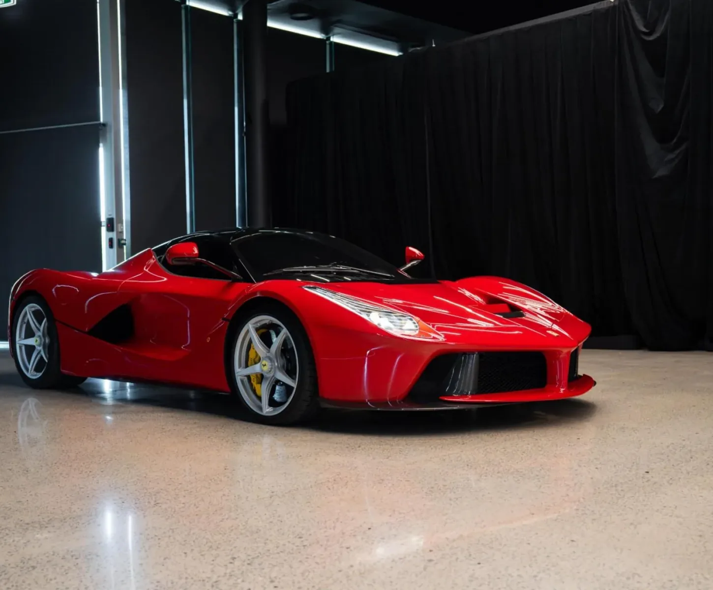LaFerrari in red, front three-quarter view in a dark studio